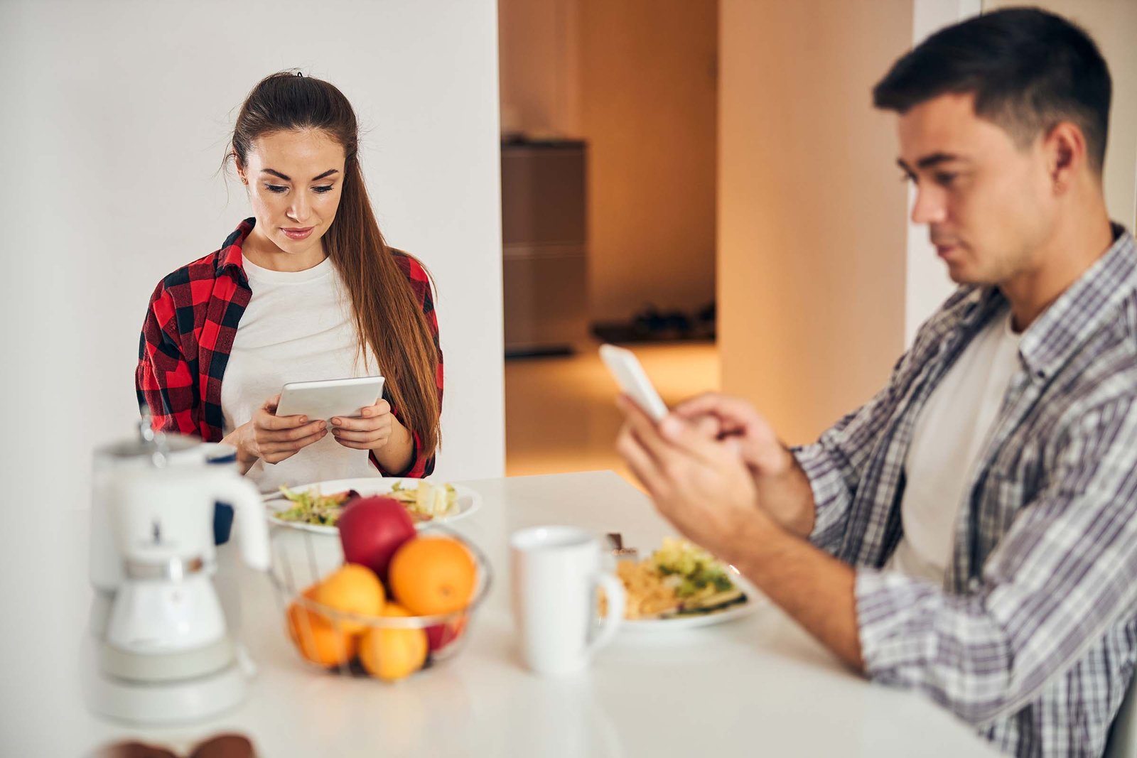 young-couple-browsing-the-web-on-their-gadgets-MS6U9BK.jpg